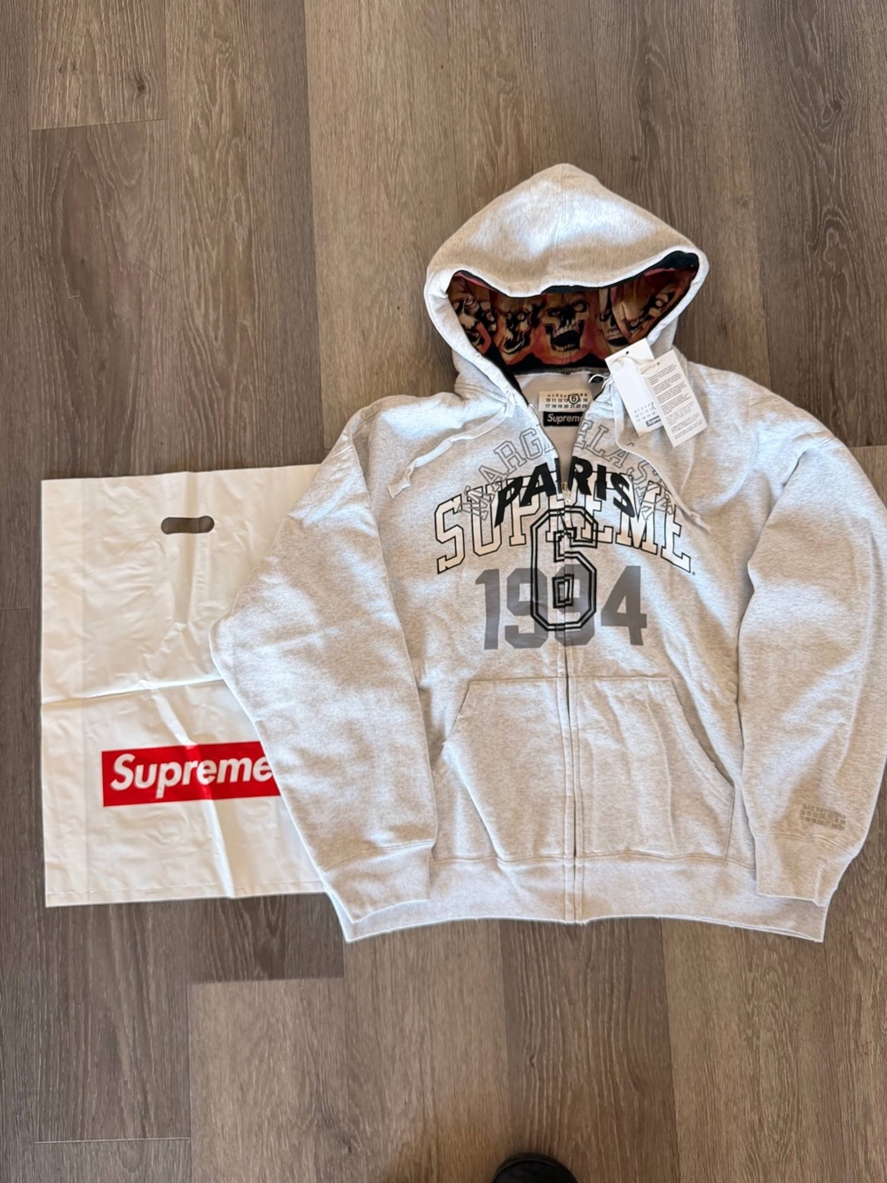 Supreme Light Gray Hooded Zip Sweater with Paris 1994 Graphic